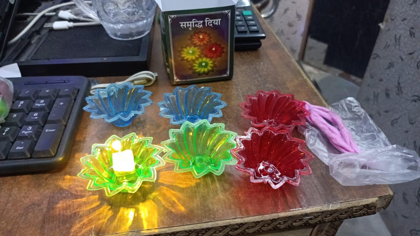 Colorful electric water sensor diyas in green red and blue arranged on a wooden table by RelaxRemo Store