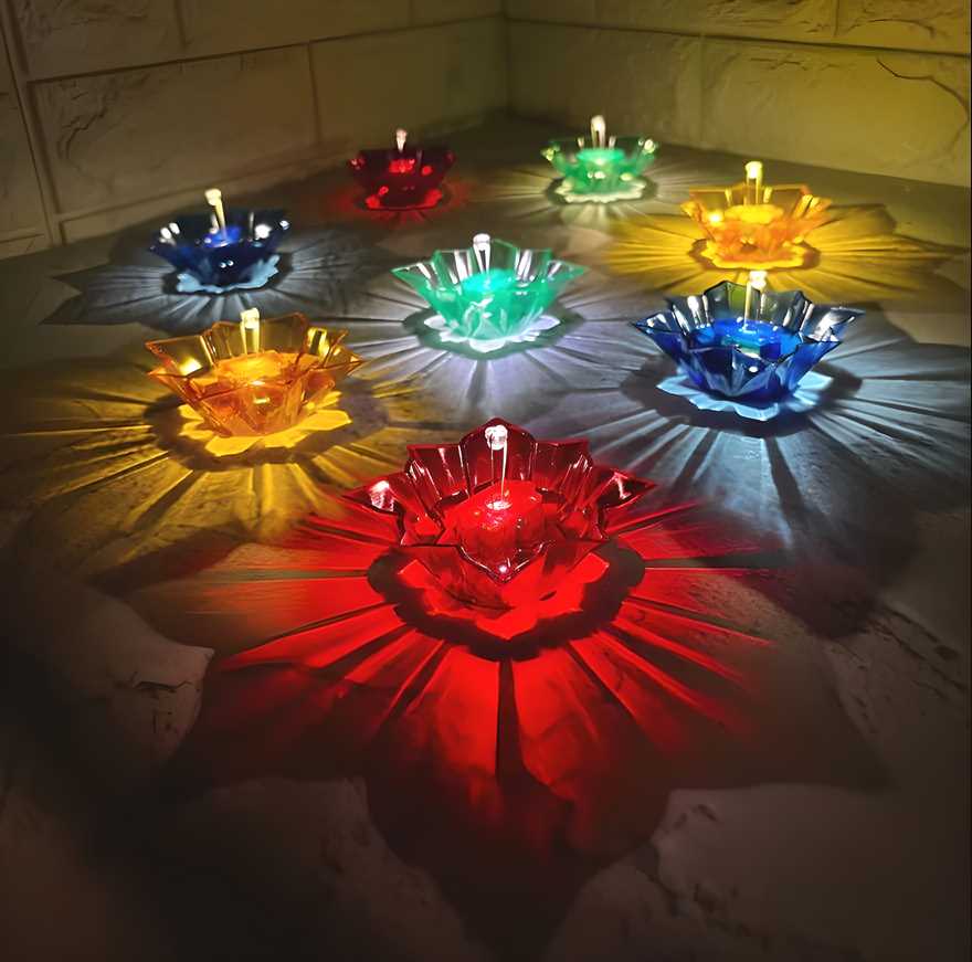 Colorful electric water sensor diyas glowing in red blue yellow and green creating decorative light patterns