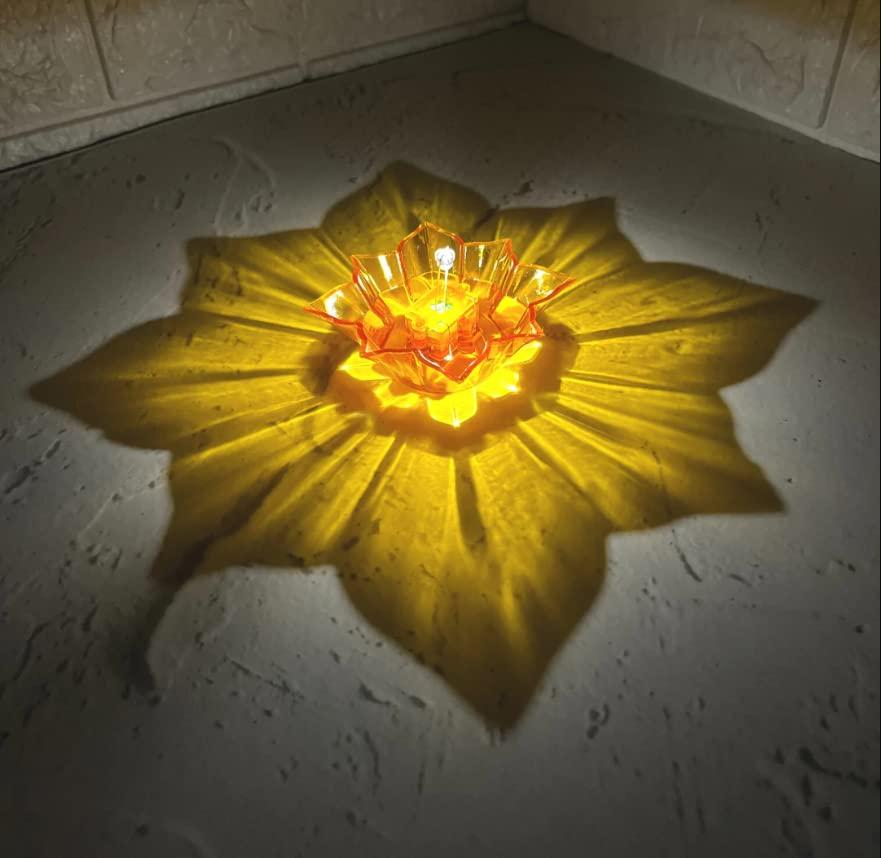 Yellow electric water sensor diyas creating a glowing flower-shaped light pattern on a surface