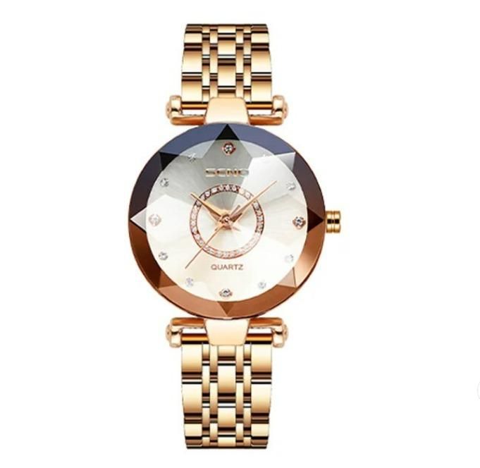 Gold tone diamond shaped ladies watch with metal link band and crystal accents on face